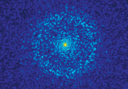 Image: Snapshot from a Livermore simulation predicts the diffraction pattern that will occur when the Linac Coherent Light Source shoots an X-ray beam at a nanolipoprotein particle (NLP). Atomic bonds appear in the pattern’s outer rings. The yellow–red spot in the middle indicates where 95 percent of the beam traveled through the NLP to the machine’s beam stop (Photo courtesy of Lawrence Livermore National Laboratory).